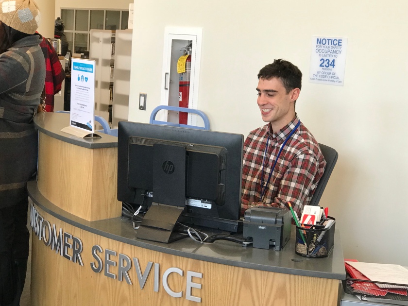 Customer service desk person smiling